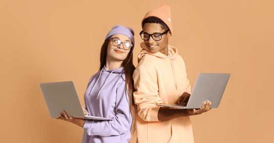 Couple in Hoodies Using Laptops - AliExpress UK vs Amazon UK: Where Should You Shop in 2025 - 2026?